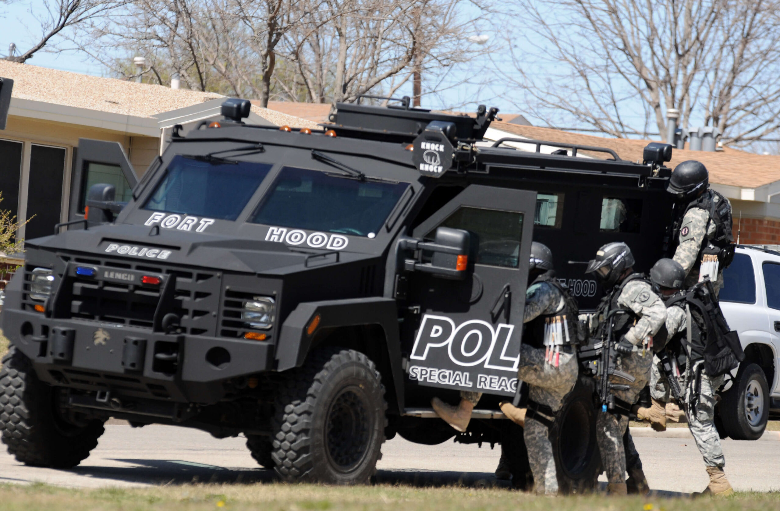 Military police Special Reaction Team members boarding a BearCat armored vehicle during a training exercise
