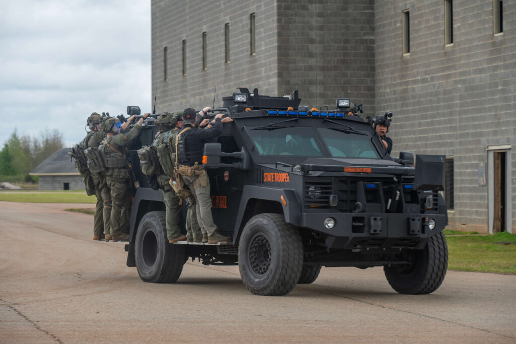 Georgia State Troopers riding on a SWAT vehicle during an emergency response training exercise